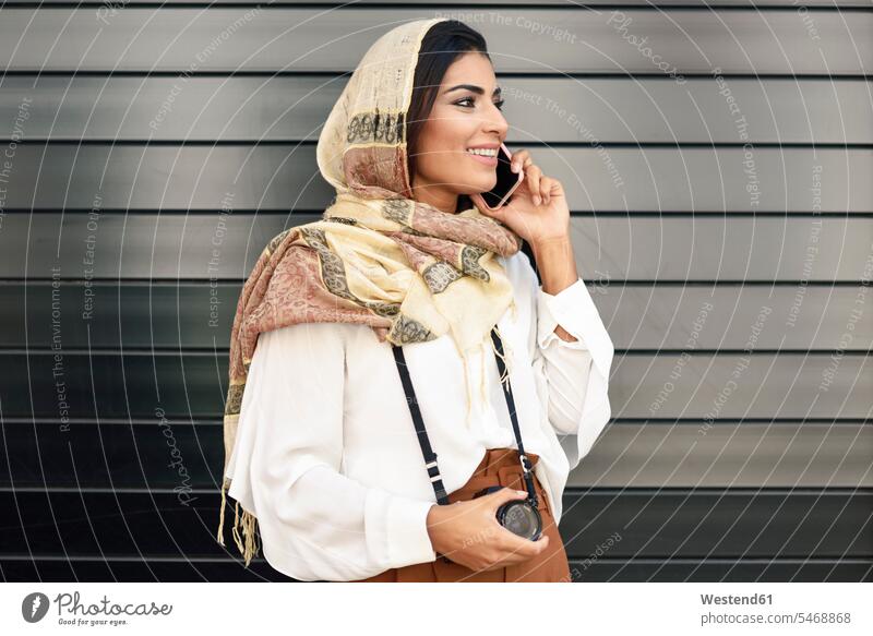 Spain, Granada, young Arab tourist woman wearing hijab, using smartphone headscarf head scarf head scarves Head Scarf head cloths headscarves female Arabian