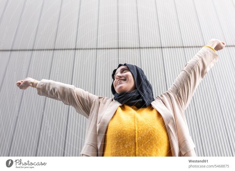 Happy young woman raising hands human human being human beings humans person persons Middle Eastern 1 one person only only one person adult grown-up grown-ups