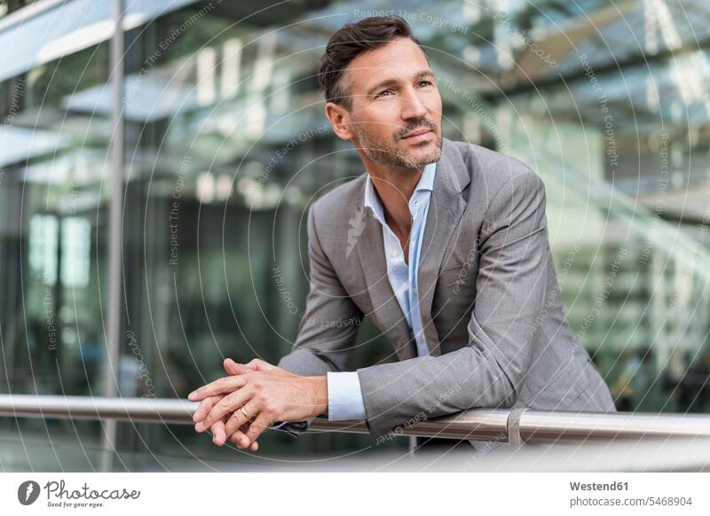 Businessman in the city leaning on railing human human being human beings humans person persons caucasian appearance caucasian ethnicity european 1