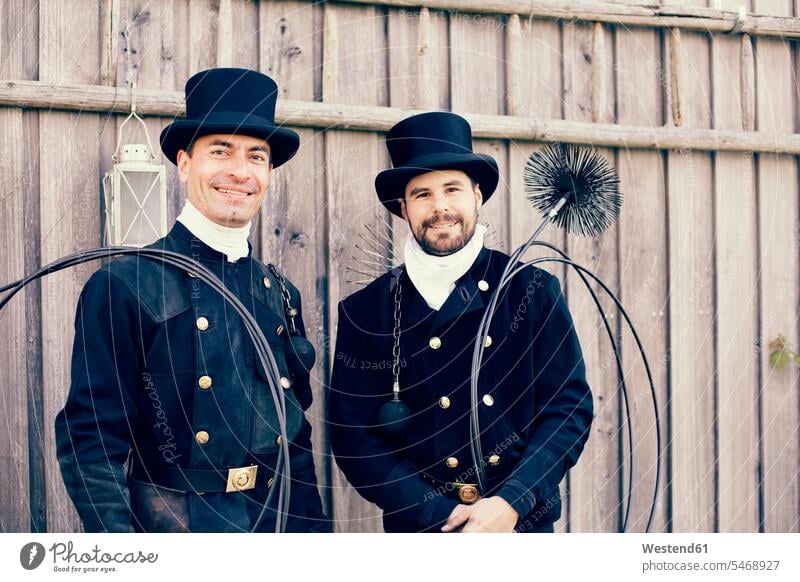 Portrait of two smiling chimney sweeps caucasian caucasian ethnicity caucasian appearance european day daylight shot daylight shots day shots daytime colleagues