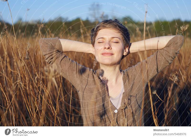 Portrait of smiling woman relaxing in nature relaxation relaxed portrait portraits natural world females women Adults grown-ups grownups adult people persons