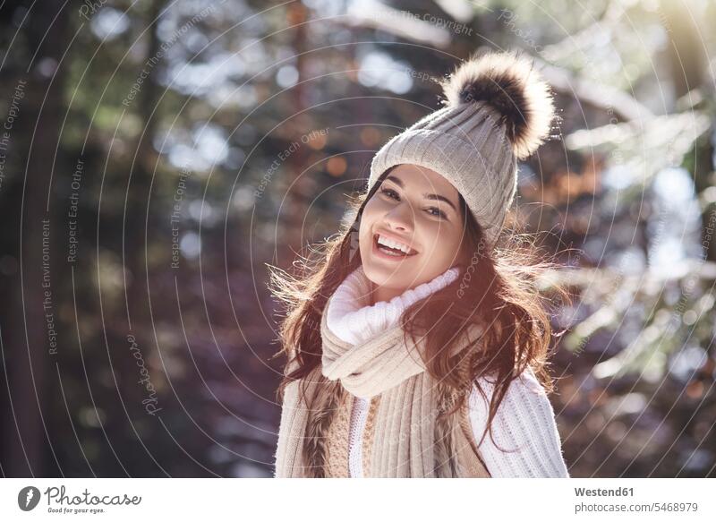 Portrait of laughing young woman wearing knitwear in winter forest females women portrait portraits hibernal woods forests Adults grown-ups grownups adult