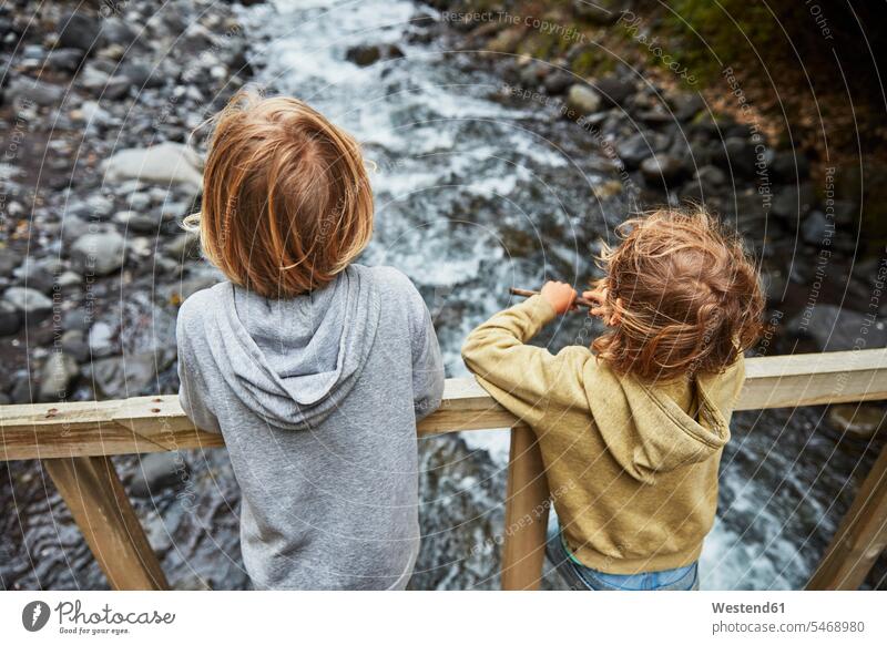 Chile, Patagonia, Osorno Volcano, Las Cascadas waterfall, two boys standing on bridge above a river River Rivers brother brothers bridges males waters