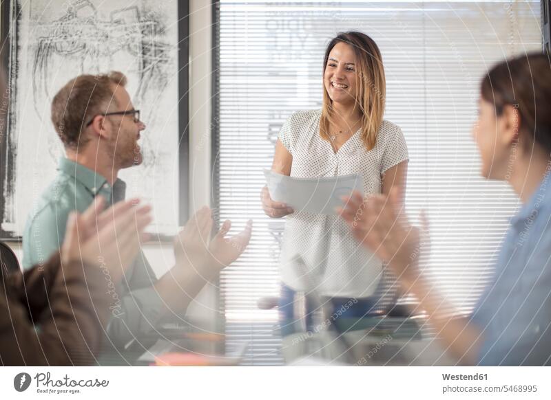 Colleagues applauding or businesswoman on a meeting in office boardroom clapping hands applause Clapping clap hands Business Meeting business conference