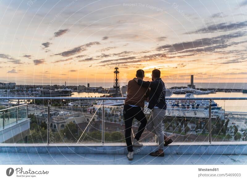 Gay couple on lookout above the city with view to the port, Barcelona, Spain human human being human beings humans person persons caucasian appearance