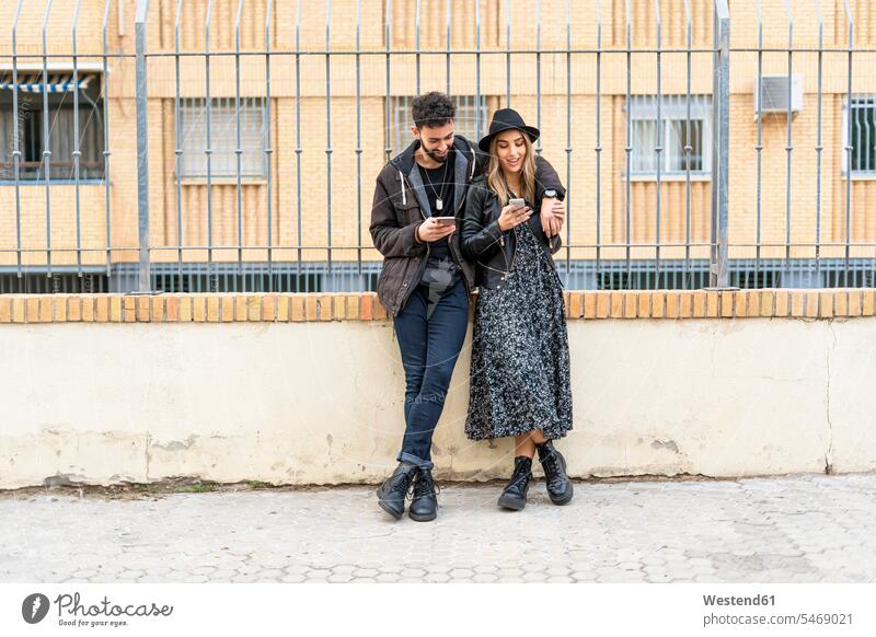 Young couple in the city using their mobile phones human human being human beings humans person persons caucasian appearance caucasian ethnicity european 2