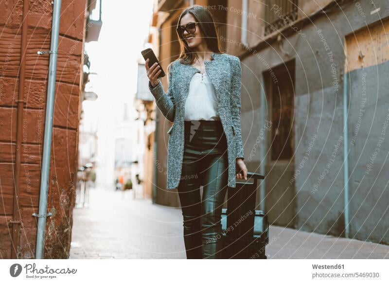 Young businesswoman in the city checking cell phone road streets roads females women Smartphone iPhone Smartphones female tourist businesswomen business woman