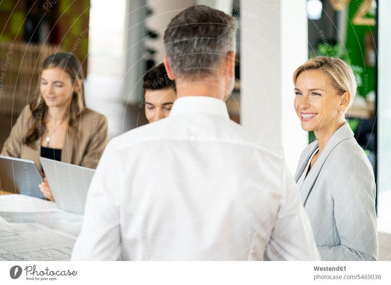 Senior businessman and woman leading workshop in office human human being human beings humans person persons caucasian appearance caucasian ethnicity european