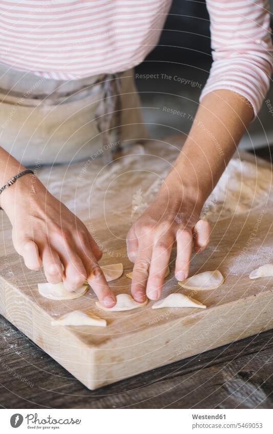 Woman preparing ravioli on pastry board woman females women preparation prepare filling stuffing pressing pushing dough Ravioli Pasta Dough Adults grown-ups