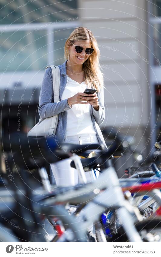 Young businesswoman texting with her mobile phone while walking business life business world business person businesspeople business woman business women