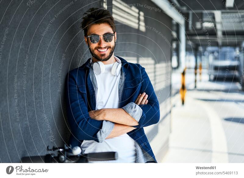 Portrait of smiling man wearing sunglasses and headphones sun glasses Pair Of Sunglasses headset men males Adults grown-ups grownups adult people persons