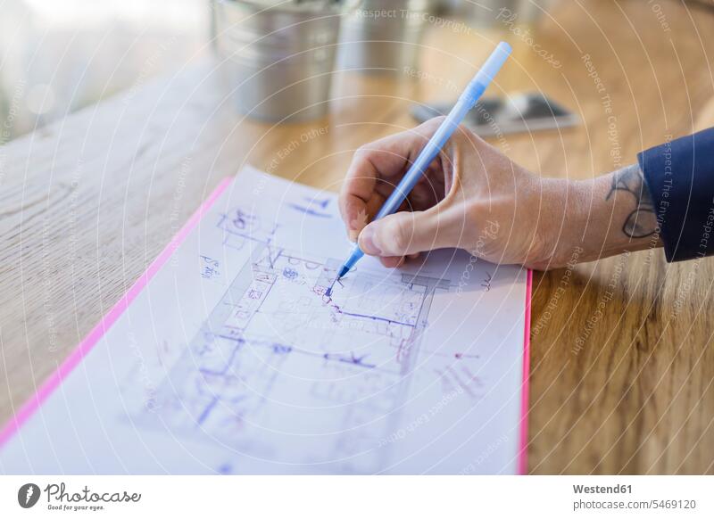 Close-up of architect working on construction plan architects building plan architectural drawing At Work occupation profession professional occupation jobs Job