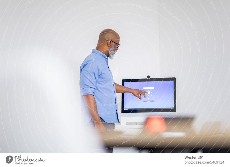 Businessman pointing on computer screen Business man Businessmen Business men point at pointing at show showing Computer Monitor computer screens