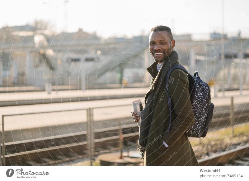Portrait of smiling man with reusable cup waiting for the train business life business world business person businesspeople Business man Business men