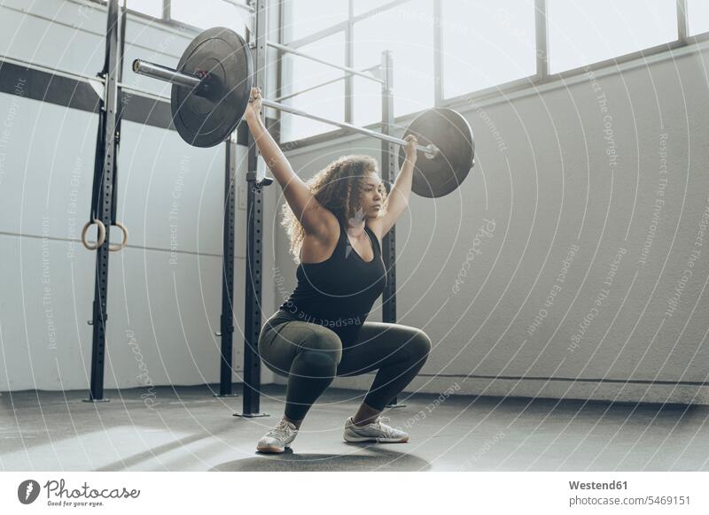 Young woman weightlifting in gym human human being human beings humans person persons Mixed Race mixed race ethnicity mixed-race Person 1 one person only