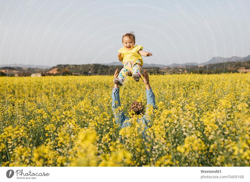 Spain, father and baby girl having fun together in a rape field daughter daughters fathers daddy dads papa Fun funny child children family families people