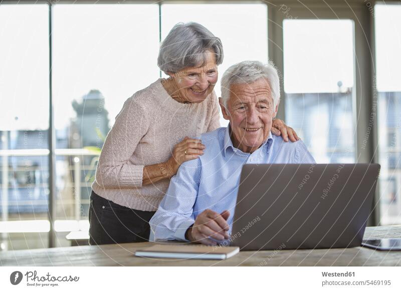 Portrait of smiling senior couple using laptop twosomes partnership couples Laptop Computers laptops notebook smile use elder couples senior couples people