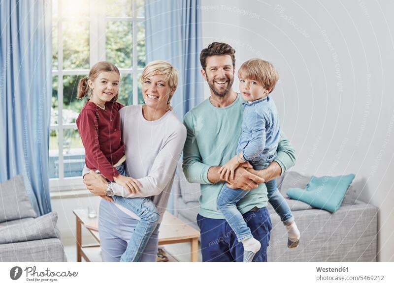 Portrait of happy family with two kids at home portrait portraits happiness families child children people persons human being humans human beings house owner