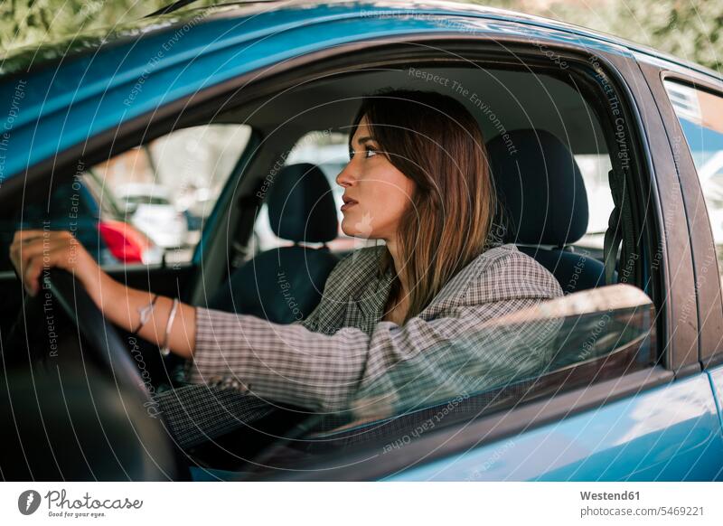 Young woman driving car color image colour image Vehicle Interior day daylight shot daylight shots day shots daytime Spain side view sideview View From Side
