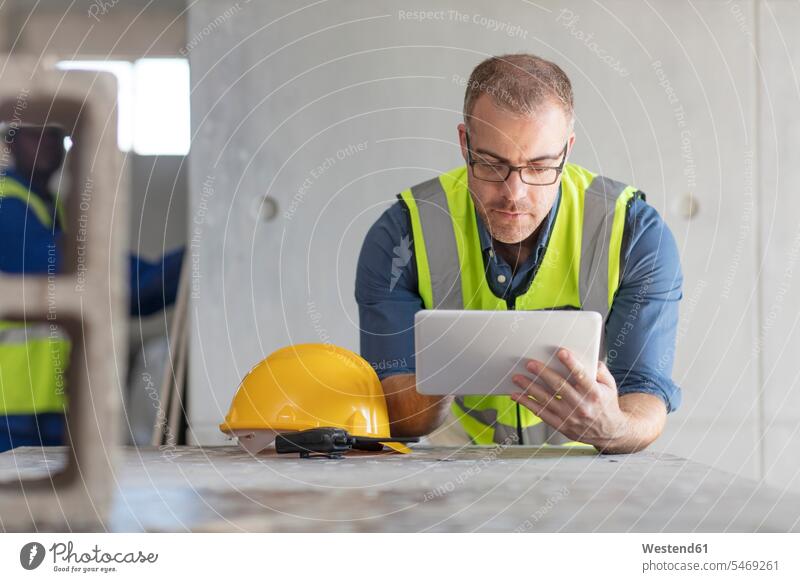 Architect using laptop at construction site using a laptop Using Laptops human human being human beings humans person persons African black black ethnicity