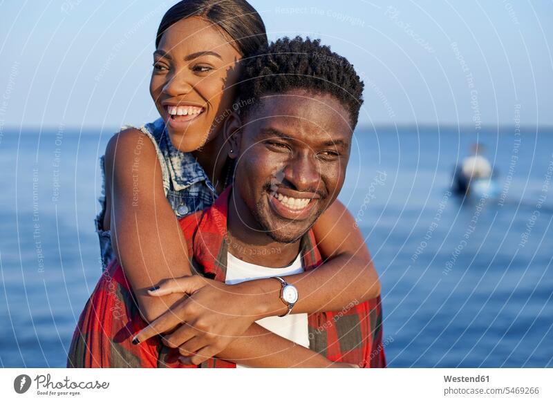 Romantic couple standing at the sea, portrait human human being human beings humans person persons African black black ethnicity coloured 2 2 people 2 persons