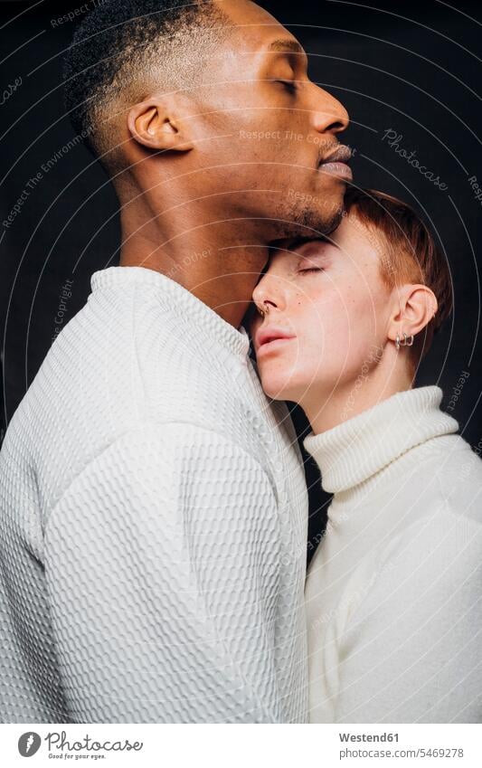 Studio portrait of affectionate mixed race couple human human being human beings humans person persons short hairs short hairstyle short hairstyles short-haired