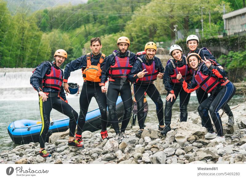 Group of playful friends at a rafting class posing at boat mate Ardor Ardour enthusiasm enthusiastic excited delight enjoyment Pleasant pleasure Cheerfulness