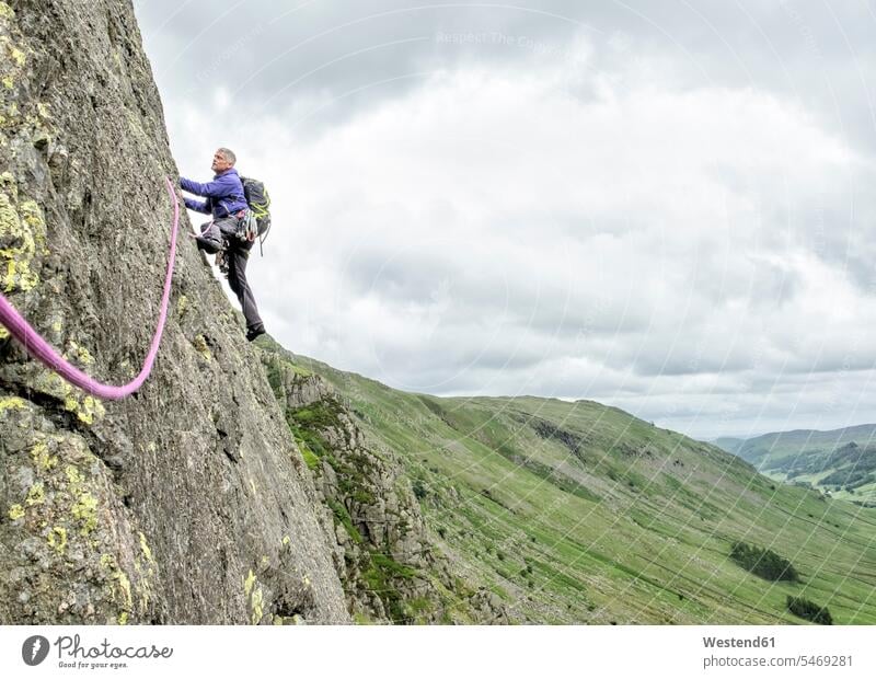 UK, Lake District, Longsleddale valley, Buckbarrow Crag, man climbing in rock wall rocks rock face escarpment males Adults grown-ups grownups adult people