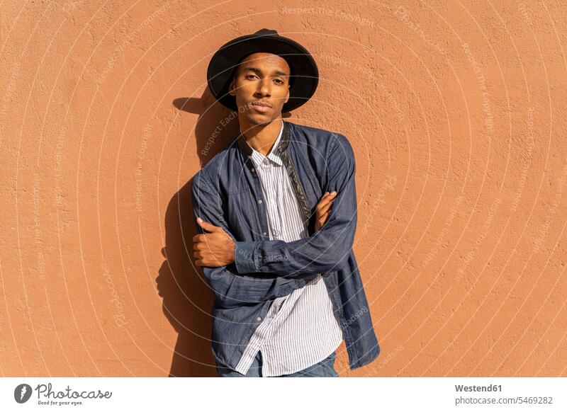 Portrait of stylish young man wearing a hat at a wall human human being human beings humans person persons African black black ethnicity coloured