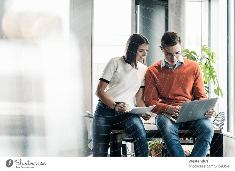 Casual businessman and woman with laptop meeting in office human human being human beings humans person persons caucasian appearance caucasian ethnicity