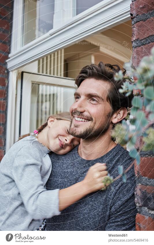 Smiling father with daughter at house entrance of their home houses daughters smiling smile pa fathers daddy dads papa at home entry Entryway entrances child