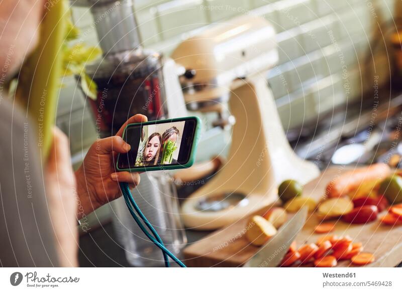 Father and daughter taking a selfie in kitchen images picture pictures photo photographs photos Device Screen Device Screens Display Screen Display Screens