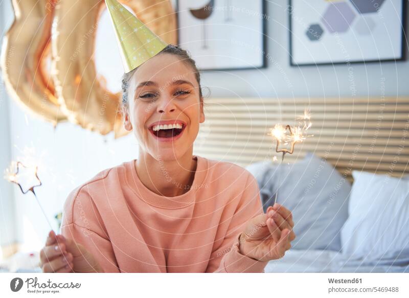 Cheerful woman during her birthday with sparklers celebrating celebrate partying Birthday Birthday Celebration Birthdays Birthday Celebrations bed beds alone