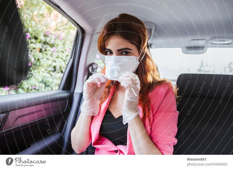 Woman wearing mask while sitting in car color image colour image Spain day daylight shot daylight shots day shots daytime Corona Virus Coronavirus disease
