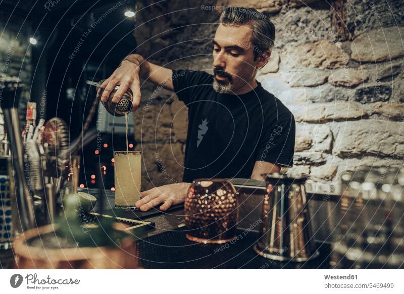 Bartender pouring cocktail in a glass human human being human beings humans person persons caucasian appearance caucasian ethnicity european 1 one person only