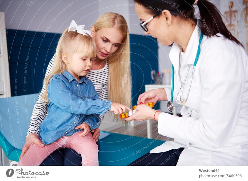 Girl receiving tablets from doctor in medical practice medical practices Doctors Office Doctor's Office Female Doctor physicians Female Doctors receive girl