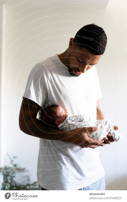Father holding his sleeping newborn baby multicultural one parent Love loving t-shirt tee-shirt T- Shirt t-shirts watching looking looking at Tenderness tender