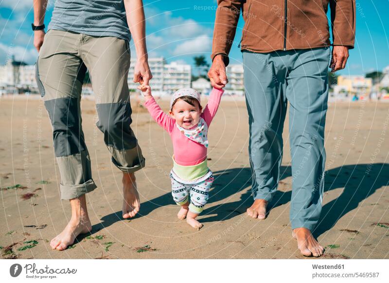 France, La Baule, portrait of happy baby girl walking on the beach with father and grandfather going happiness infants nurselings babies portraits pa fathers
