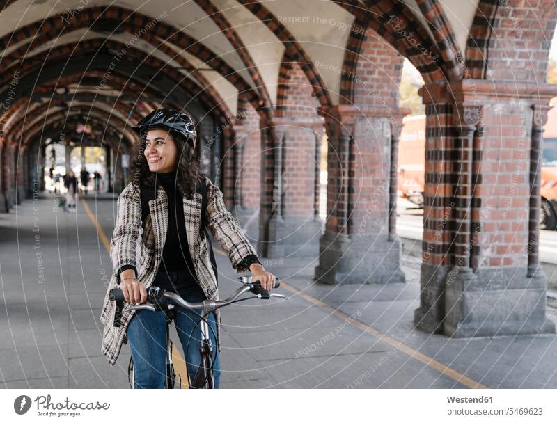 Happy woman riding bicycle in the city, Berlin, Germany bikes bicycles Cycle Cycle - Vehicle smile travel traveling delight enjoyment Pleasant pleasure