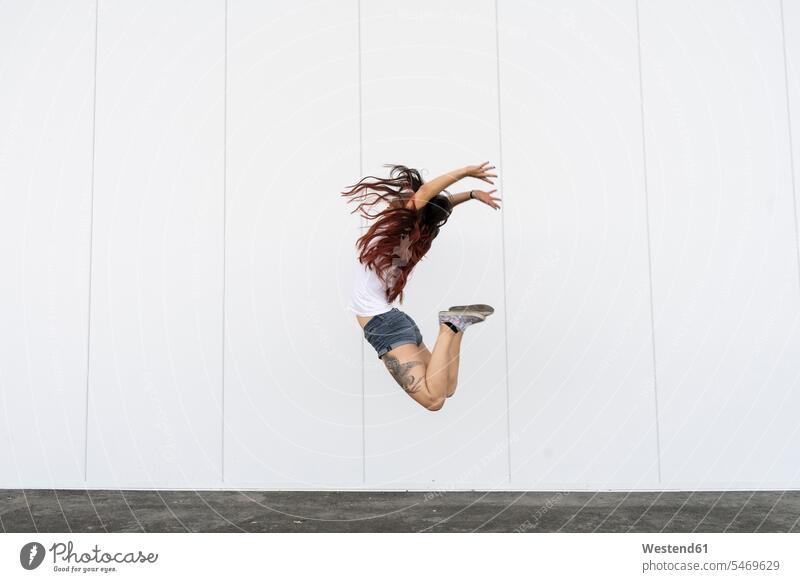 Young acrobat jumping in air acrobats equilibrists exercise exercises practising exercising female artist female artists Leaping jumps Freedom Liberty free