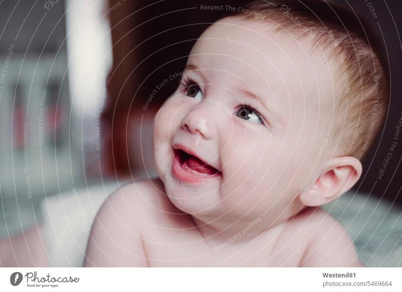 Close-up of cute shirtless baby girl looking away at home color image colour image Spain indoors indoor shot indoor shots interior interior view Interiors