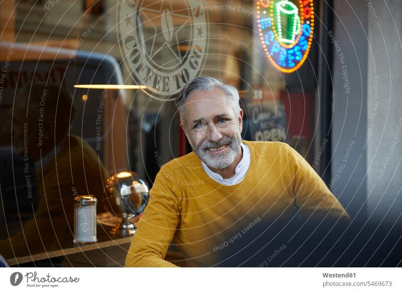Portrait of smiling mature man in a cafe human human being human beings humans person persons celibate celibates singles solitary people solitary person
