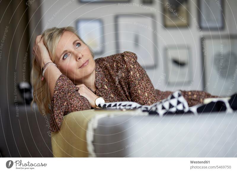 Blond woman relaxing at home sitting on couch human human being human beings humans person persons caucasian appearance caucasian ethnicity european 1