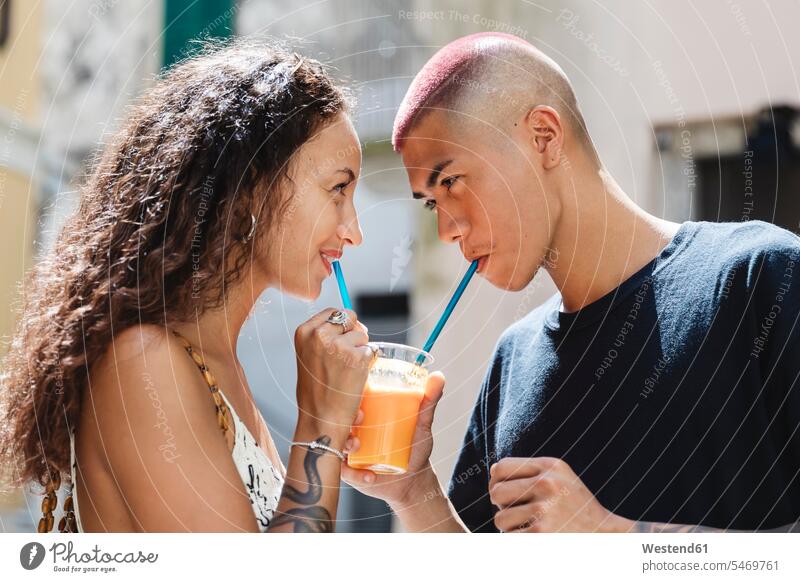 Young couple drinking fruit juice together touristic tourists drinking straw drinking straws smile delight enjoyment Pleasant pleasure happy Emotions Feeling