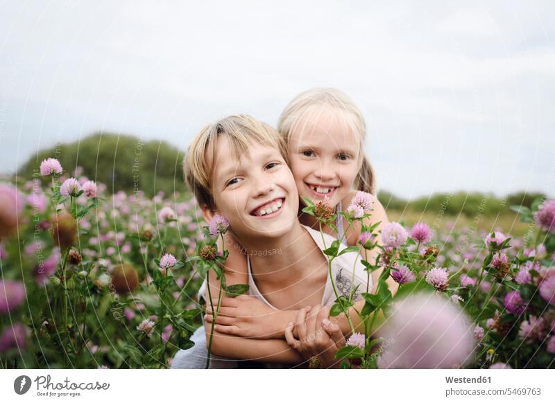 Two smiling children on clover field human human being human beings humans person persons caucasian appearance caucasian ethnicity european 2 2 people 2 persons