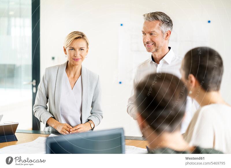 Senior businessman and woman leading workshop in office human human being human beings humans person persons caucasian appearance caucasian ethnicity european