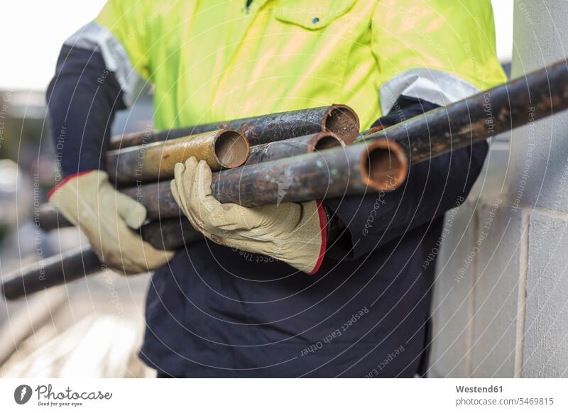 South Africa, Cape Town, Builder holding pipes worker blue collar worker workers blue-collar worker occupation profession professional occupation jobs