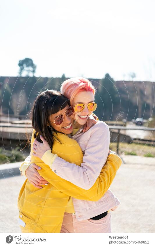 Portrait of two alternative friends embracing female friends equality Alternative embrace Embracement hug hugging homosexual woman lesbians gay women gay woman