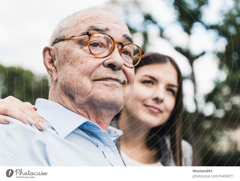 Portrait of self-confident senior man with granddaughter in the background human human being human beings humans person persons caucasian appearance