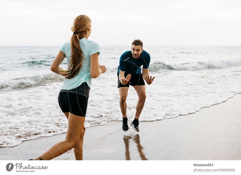 Female jogger on the beach with her coach human human being human beings humans person persons caucasian appearance caucasian ethnicity european 2 2 people